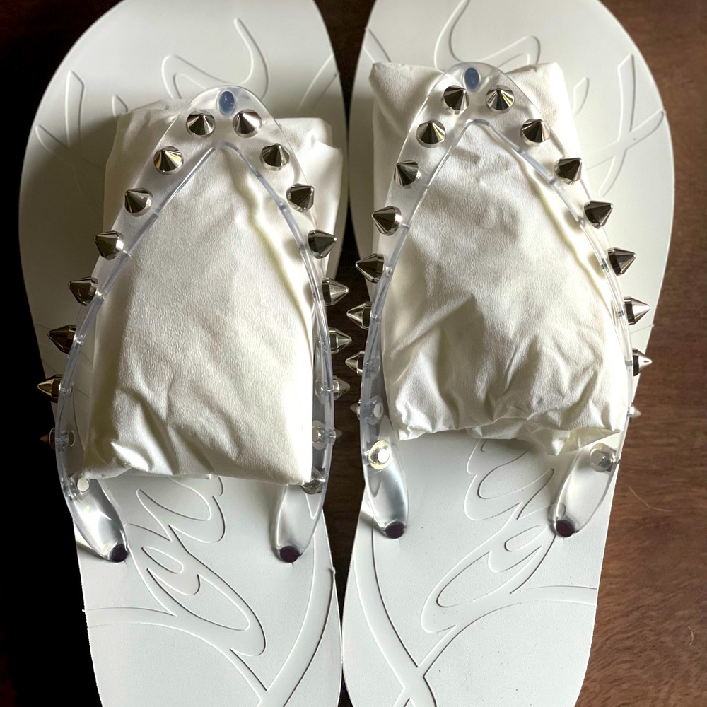 Brand new in box louboutin flip flops in white. Size 39. Retails 395 plus tax!